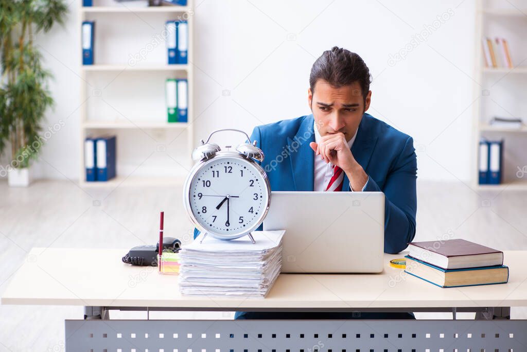 Young male employee working in the office