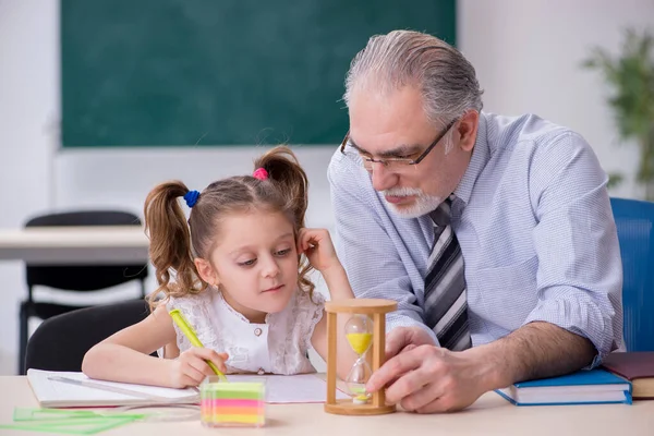 Oude leraar en schoolmeisje op school — Stockfoto