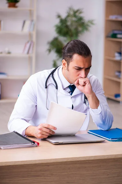 Young male doctor working in the clinic — Stock Photo, Image