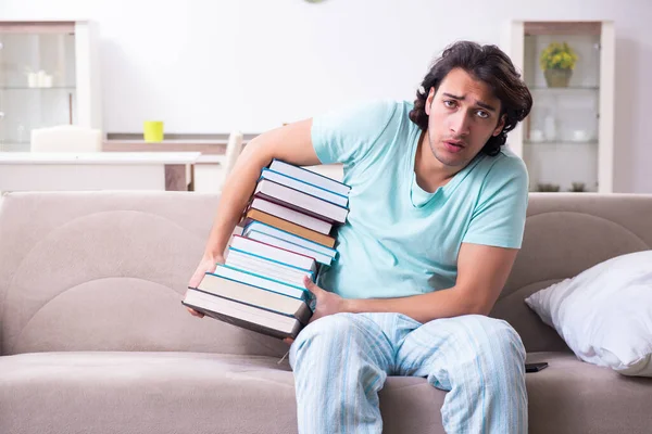 Young male student unhappy with excessive work at home — ストック写真