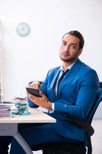 Young male accountant in budget planning concept — Stock Photo, Image