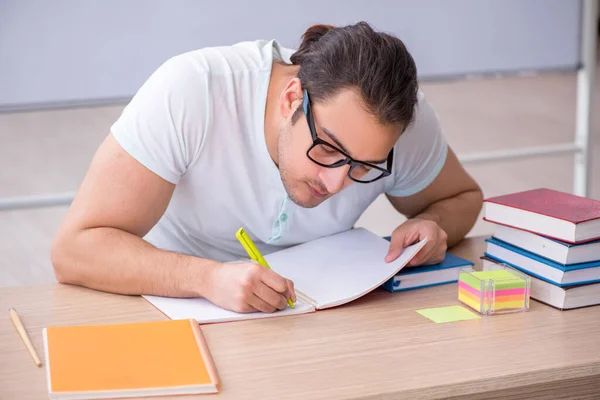 Young male teacher student sitting in the classroom — Stock Photo, Image