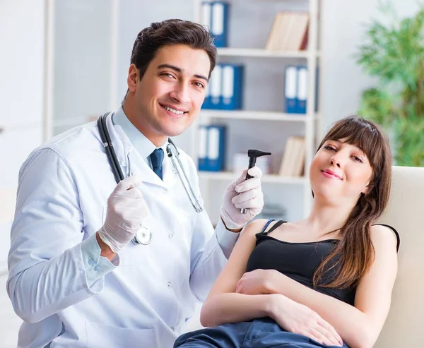 Doctor checking patients ear during medical examination