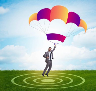 Genç işadamı iş konseptinde paraşütle atlıyor