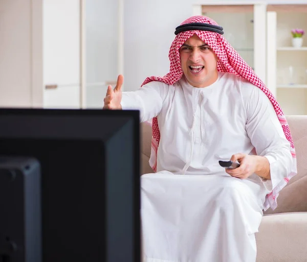 Arab businessman watching tv at home — Stock Photo, Image