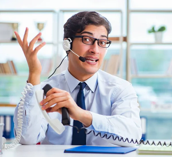 Unhappy angry call center worker frustrated with workload