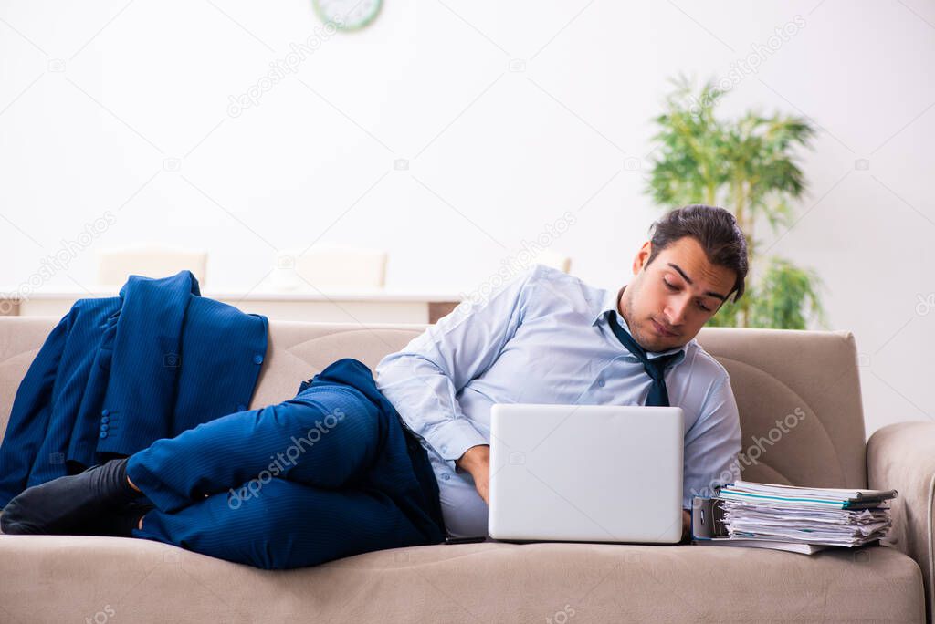 Young male employee working from house