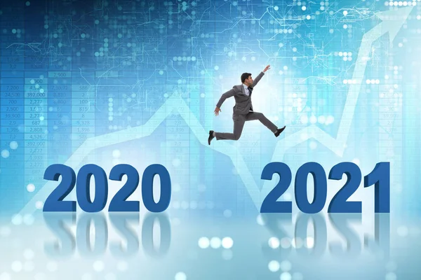 Businessman jumping from the year 2020 to 2021 — Stock Photo, Image