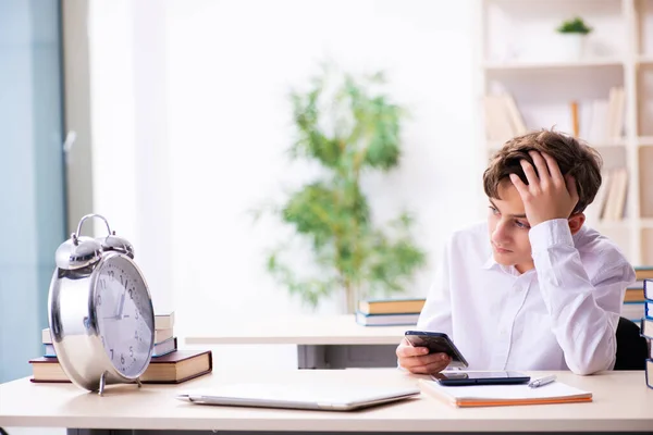 Schoolboy in time management concept in the classroom — Stock Photo, Image