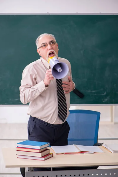 Old male teacher in the classroom — Stock Photo, Image