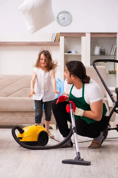Young male contractor cleaning the house with his small daughter — Stock Photo, Image