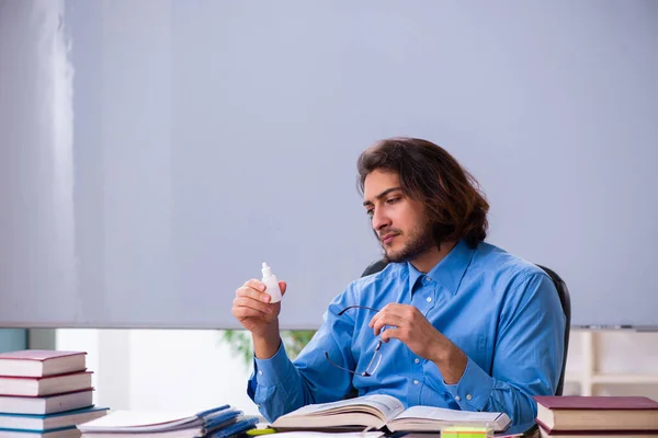 Young male teacher in the classroom — Stock Photo, Image