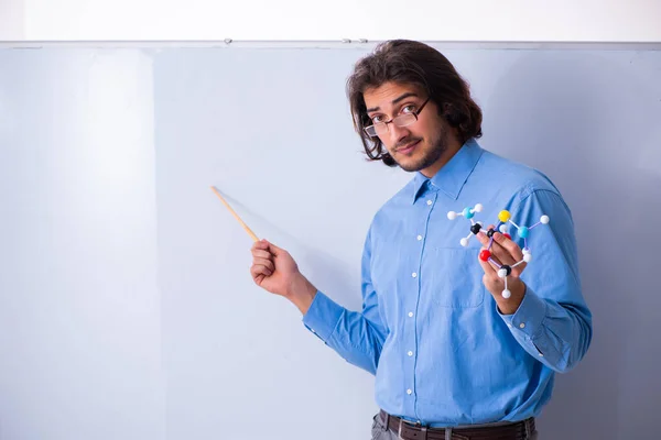 Young male teacher in the classroom — Stock Photo, Image