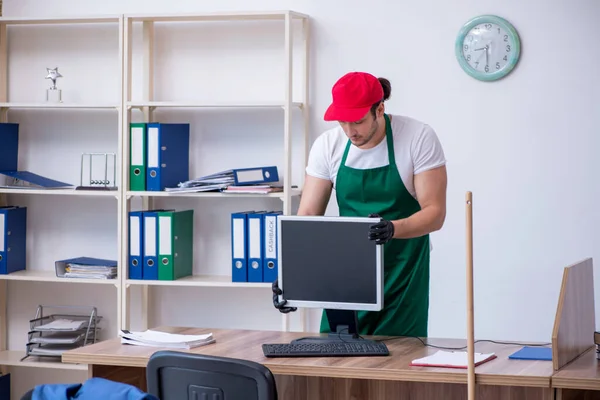 Young male contractor cleaning the office — Stock Photo, Image