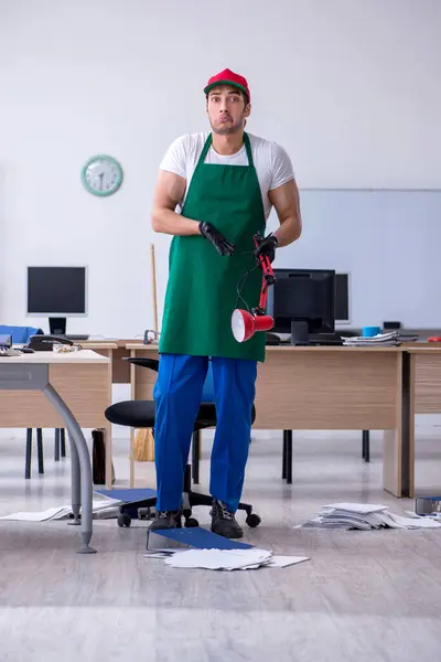 事務所を掃除する若い男の請負業者 — ストック写真