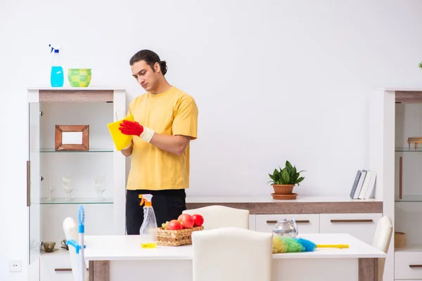 Young male contractor cleaning the house — Stock Photo, Image