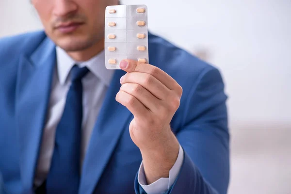 Young male sick employee suffering at workplace — Stock Photo, Image