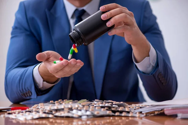 Young male sick employee suffering at workplace — Stock Photo, Image