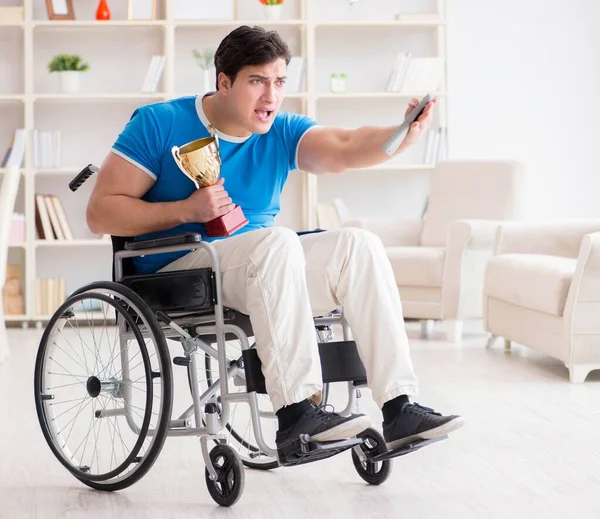 Disabled man watching sports on tv — Stock Photo, Image