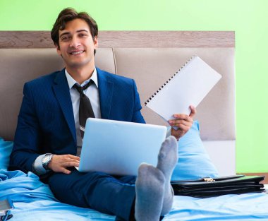 Otel odasında çalışan bir iş adamı.