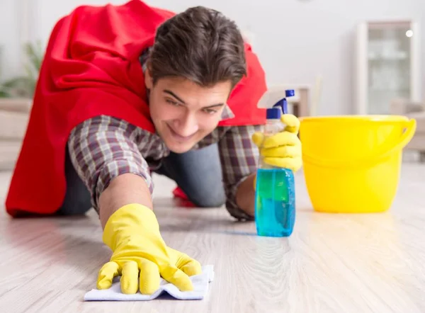 Super hero husband cleaning floor at home — Stock Photo, Image