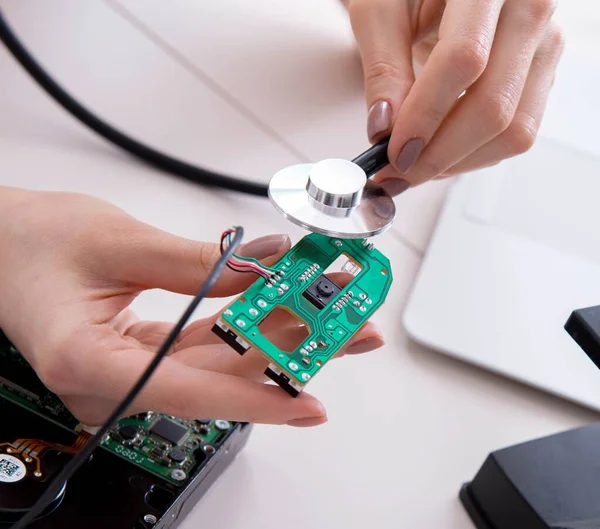 Engineer fixing broken computer hard drive