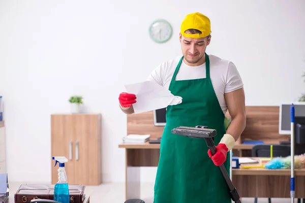 Jonge mannelijke aannemer schoonmaken van het kantoor — Stockfoto