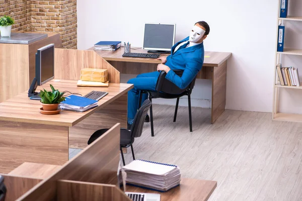 Young male employee wearing mask in the office