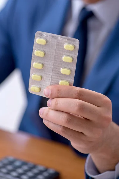 Young male sick employee suffering at workplace — Stock Photo, Image