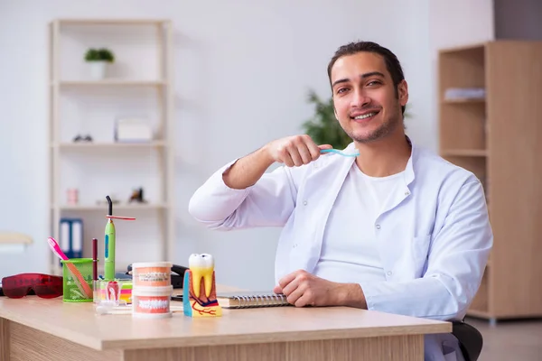 Young male dentist working in the clinic — Stock Photo, Image