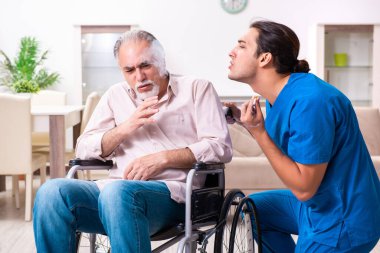 Tekerlekli sandalyedeki yaşlı adam ve genç kötü bakıcı.