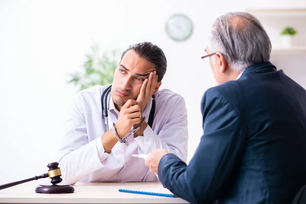 Male doctor in courthouse meeting with lawyer