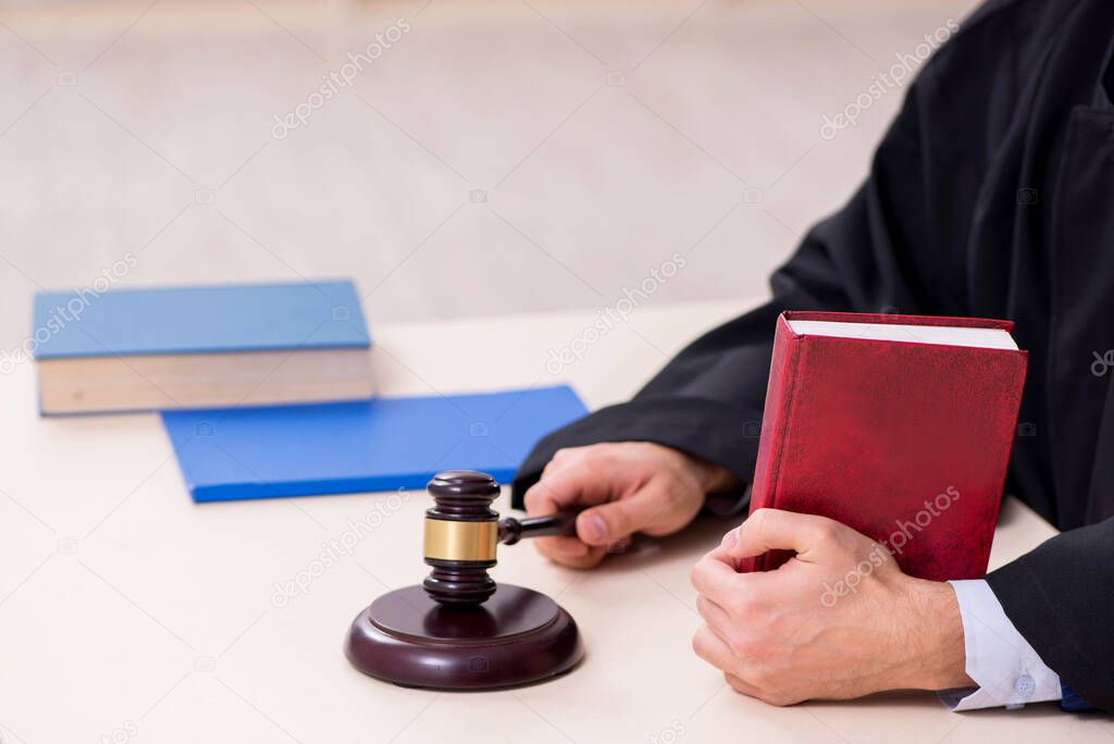 Young male judge working in courthouse