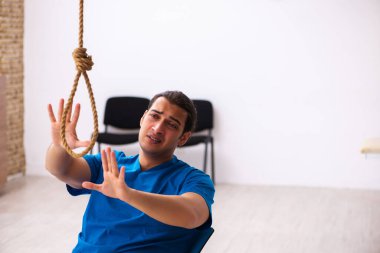 Genç erkek doktor iş yerinde intihar ediyor.