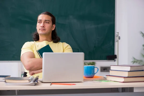 Young male student preparing for exams in the classroom — Stock Photo, Image