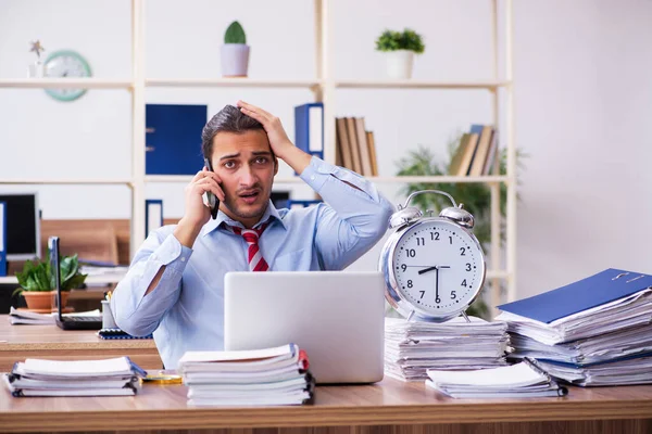 Young male employee unhappy with excessive work in time manageme — Stock Photo, Image