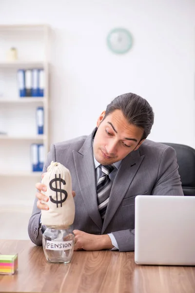 Young male employee in pension concept at workplace — Stock Photo, Image