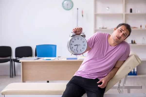 Young male patient waiting for doctor in time management concept — Stock Photo, Image