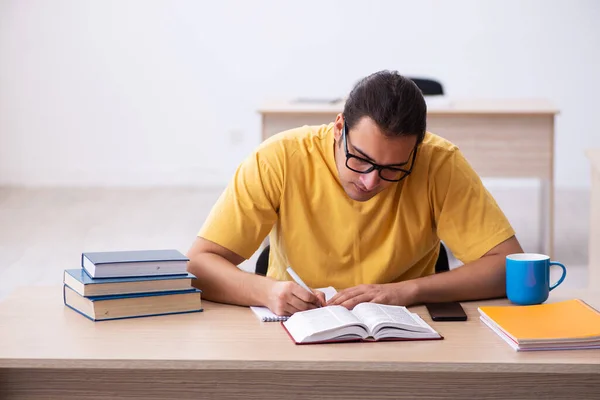 Jovem estudante do sexo masculino tomando notas durante a preparação do exame — Fotografia de Stock