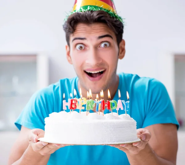 Young man celebrating birthday alone at home