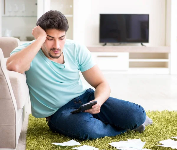 Young man struggling with personal finance and bills — Stock Photo, Image