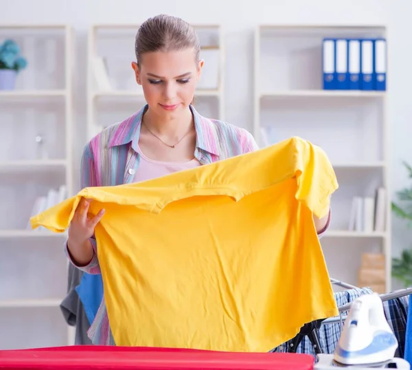 Young housewife doing laundry at home — Stock Photo, Image