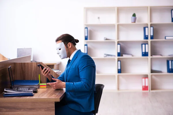 Young male employee wearing mask in the office