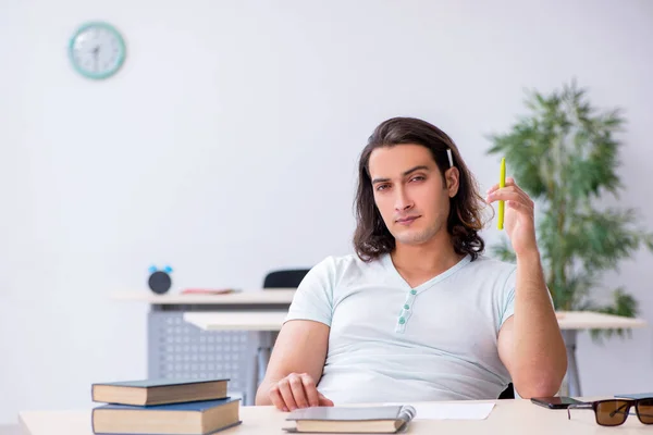 Young male student preparing for exam in the classroom — Stock Photo, Image