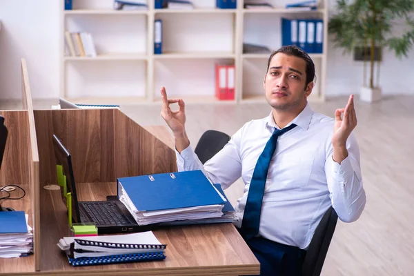 Jovem funcionário masculino infeliz com excesso de trabalho no escritório — Fotografia de Stock