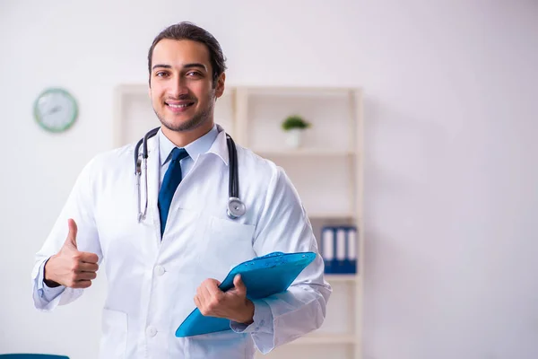 Jeune homme beau médecin travaillant à la clinique — Photo