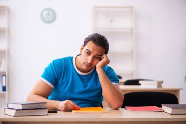 Sınavlara hazırlanan bitkin erkek öğrenci.