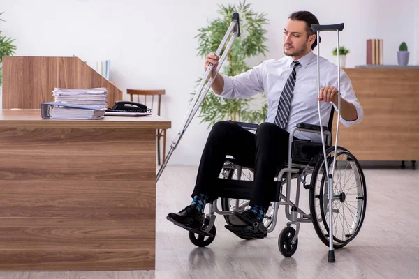 Young disabled employee suffering at workplace