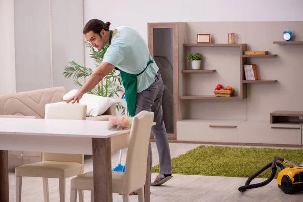 Young male contractor cleaning the house — Stock Photo, Image