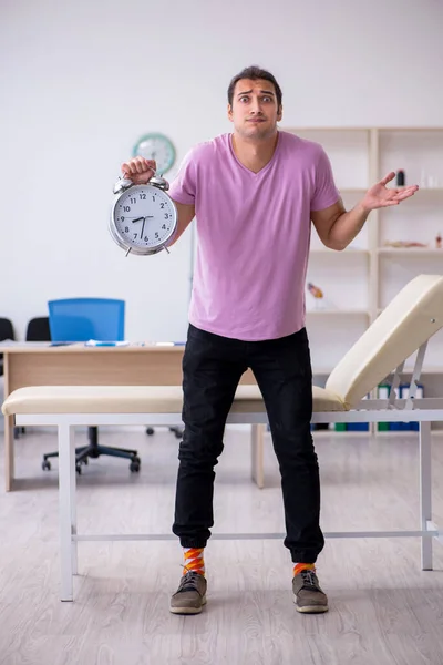 Young male patient waiting for doctor in time management concept — Stock Photo, Image